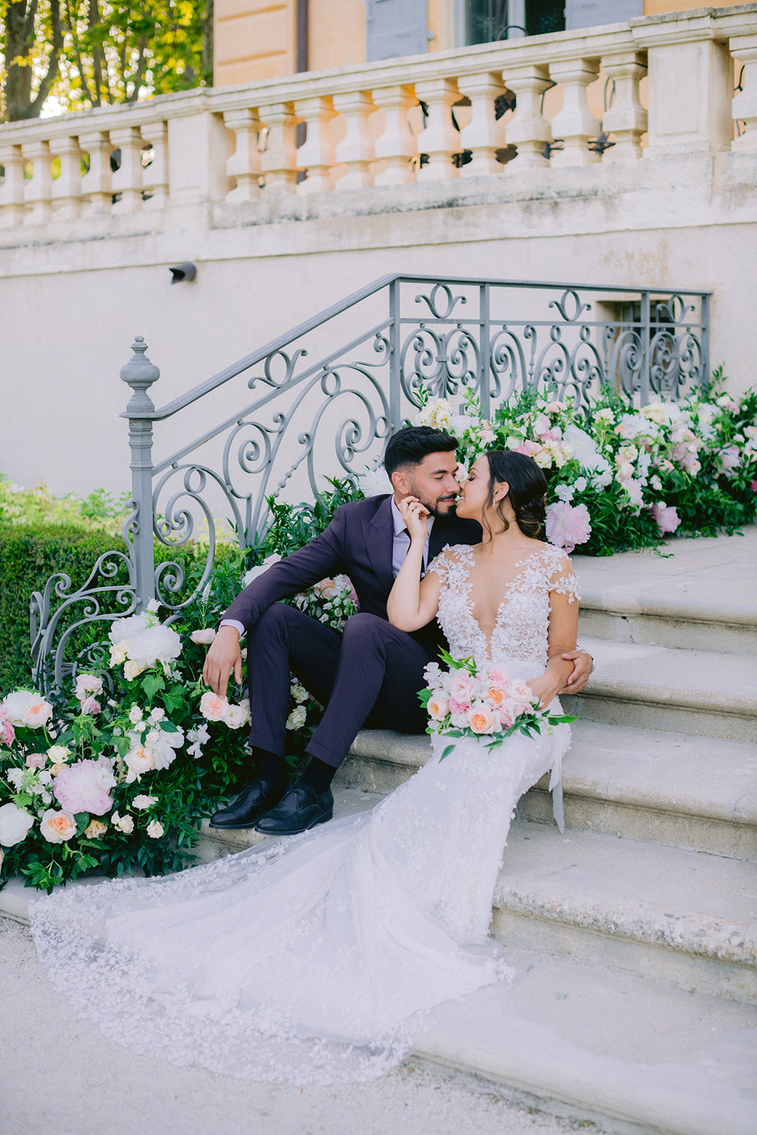 the couple kiss on the steps of the castle